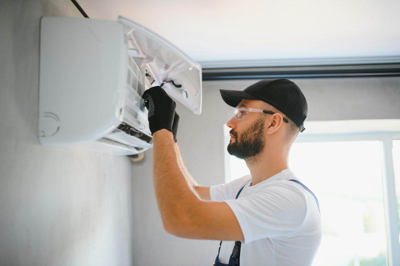 Horizon Air technician performing AC maintenance and inspection on a residential air conditioning system