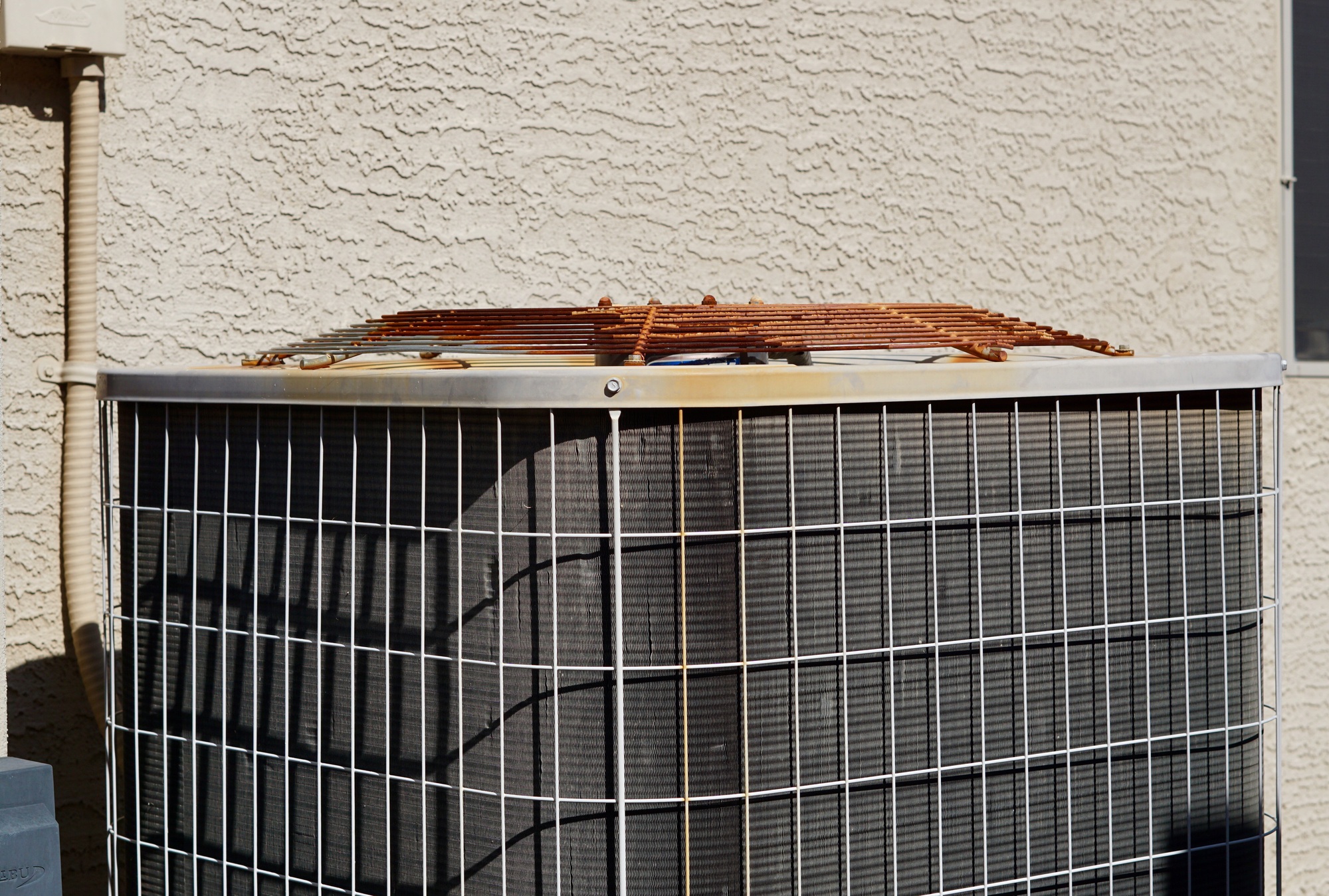 Side‑by‑side view of an outdated AC unit and a new high-efficiency heat pump in Bullhead City